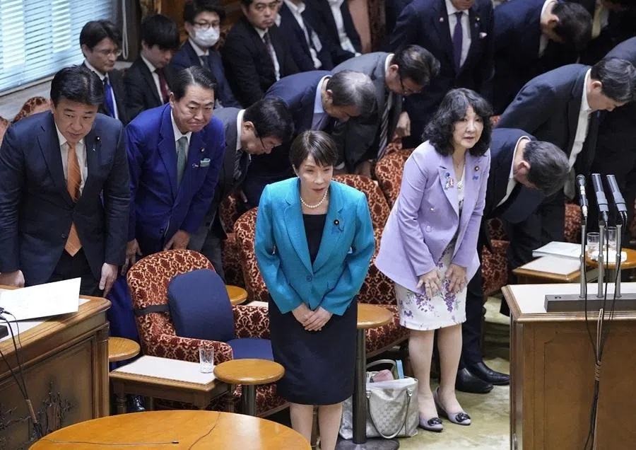 Japan's Prime Minister Sanae Takaichi (centre) bows after the House of Councillors Budget Committee passed the FY2026 supplementary budget inside the National Diet Building on 5 June 2026.