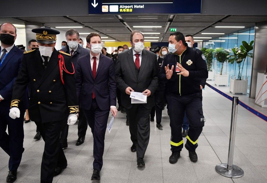 French Health Minister Francois Braun (second from right) and French Junior Minister for Transport Clement Beaune (third from right) arrive for a visit at the Paris-Charles-de-Gaulle airport in Roissy, outside Paris, on 1 January 2023, as France reinforces health measures at the borders for passengers arriving from China. (Julien de Rosa/AFP)