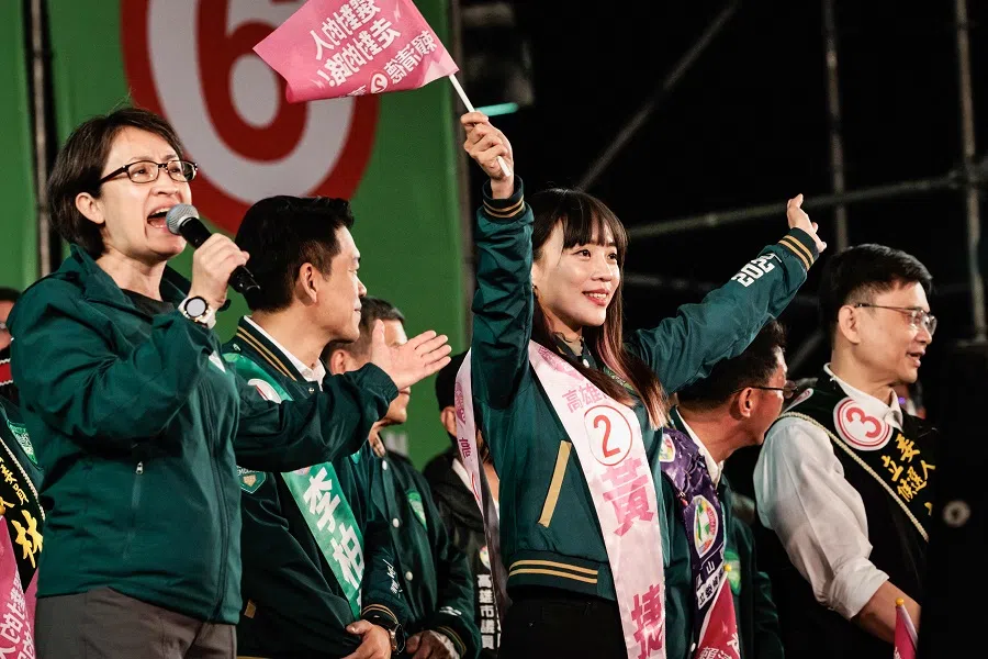 This picture taken on 7 January 2024, shows Huang Jie (arms raised), Kaohsiung city councillor and the Democratic Progressive Party (DPP) legislative candidate who is a staunch supporter of LGBTQ rights, being introduced on stage by DPP vice-presidential candidate Hsiao Bi-khim (left) during a DPP campaign rally in Kaohsiung. (Yasuyoshi Chiba/AFP)