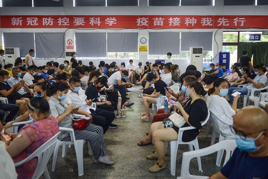 This photo taken on 10 August 2021 shows people in observation after receiving the Covid-19 vaccine in Ningbo, Zhejiang province, China. (STR/AFP)