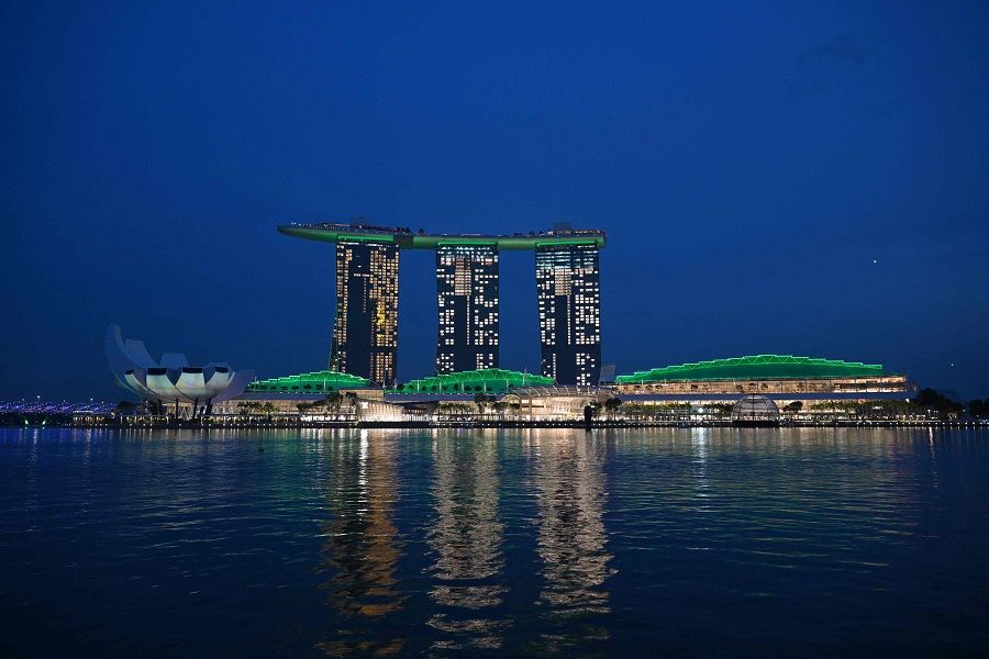 The Marina Bay Sands hotel resort is seen lit up in green in Singapore on 6 November 2023. (Mohd Rasfan/AFP)