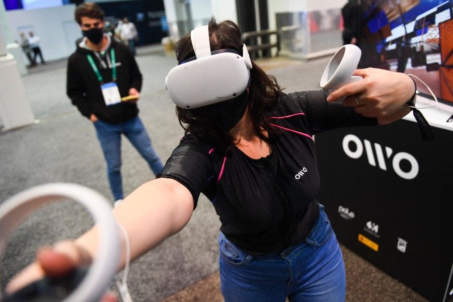 A user demonstrates the Owo vest, which allows users to feel physical sensations during metaverse experiences such as virtual reality games, including wind, gunfire or punching, at the Consumer Electronics Show on 5 January 2022 in Las Vegas, Nevada. (Patrick T. Fallon/AFP)