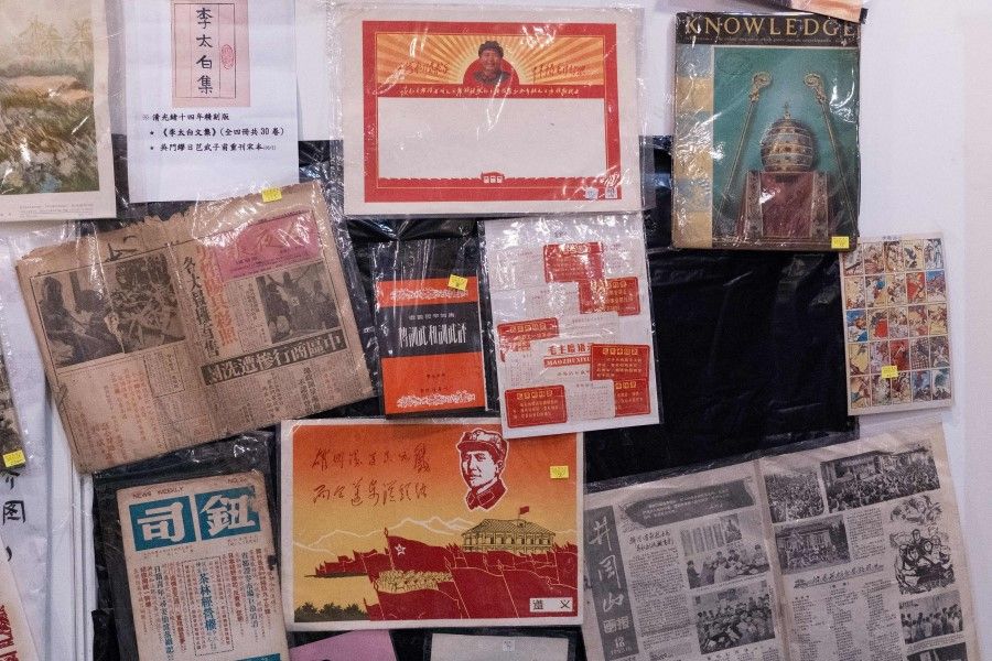 Old Chinese newspapers and posters on former Chinese chairman Mao Zedong are displayed at the annual Hong Kong Book Fair in Hong Kong on 17 July 2021. (Bertha Wang/AFP)