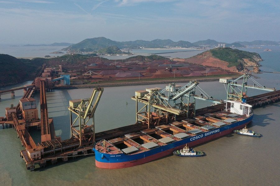 A China Ocean Shipping Company (COSCO) vessel is seen docked after unloading the imported iron ore at a port in Zhoushan, Zhejiang province, China, 9 May 2019. (Stringer/Reuters)