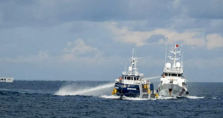 A China Coast Guard vessel 21559 uses a water cannon against Philippines Bureau of Fisheries and Aquatic Resources ship BRP Datu Pagbuaya in the South China Sea, in this handout image released by the Philippine Coast Guard on 12 October 2025.