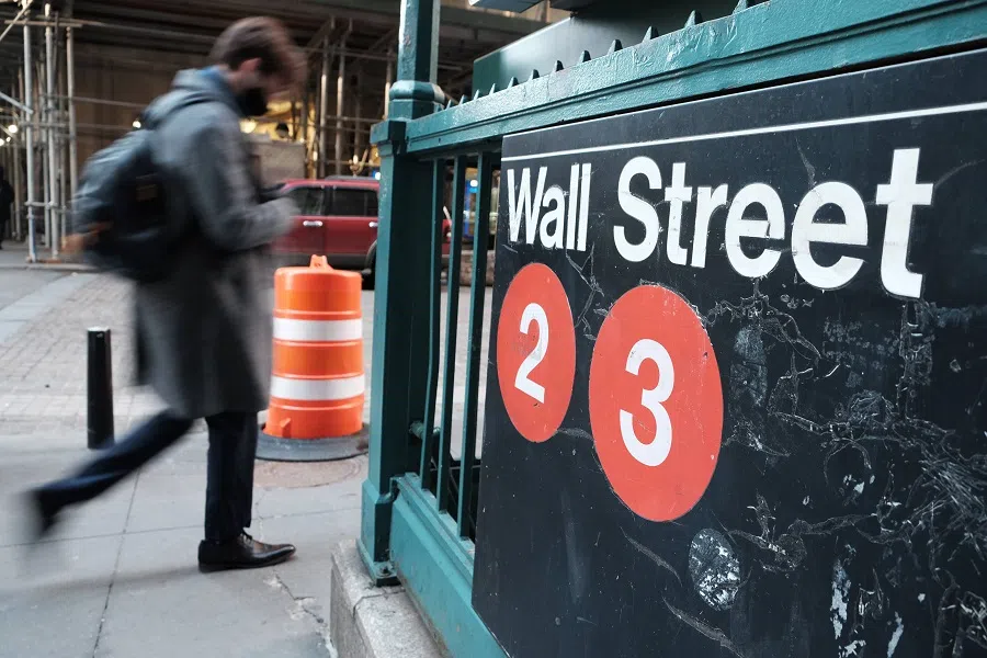 A man walks by a subway stop on Wall Street by the New York Stock Exchange (NYSE) on 11 January 2022 in New York City, US. (Spencer Platt/Getty Images/AFP)