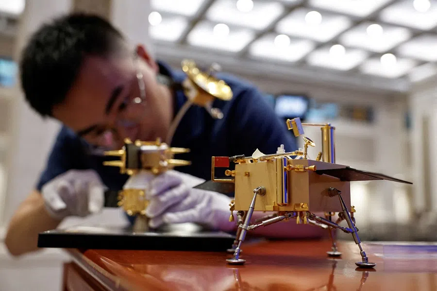 A staff member assembles a model of Chang’e 6 lunar probe ahead of a press conference on Chang’e 6 mission of China’s lunar exploration program, in Beijing, China, 27 June 2024.