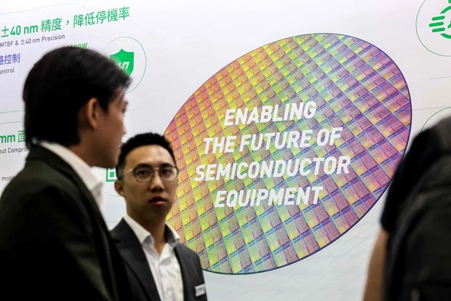 Visitors stand in front of an image of a semiconductor wafer during SEMICON Taiwan in Taipei on 2 September 2026.