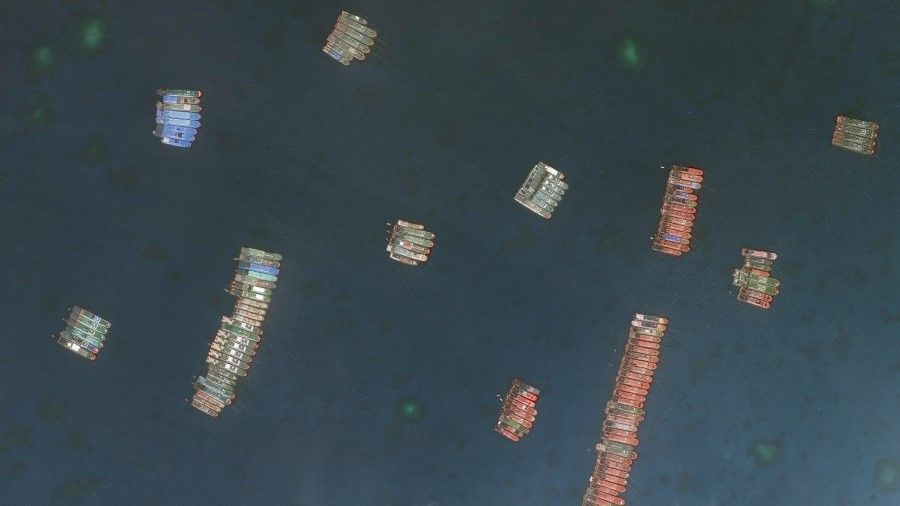 Chinese militia vessels tied up at Whitsun Reef, 25 March 2021, during the diplomatic incident with the Philippines. China said the boats were seeking shelter from rough weather and not acting as militia, but the report said there was no commercial rationale for a large fleet of fishing vessels to operate in this manner, loitering in large clusters for weeks at a time. (CSIS Asia Maritime Transparency Initiative/Maxar Technologies)