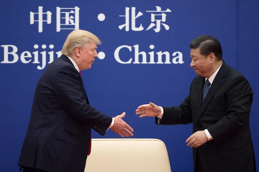 Chinese President Xi Jinping shakes hands with US President Donald Trump during a business leaders event at the Great Hall of the People in Beijing on 9 November 2017.