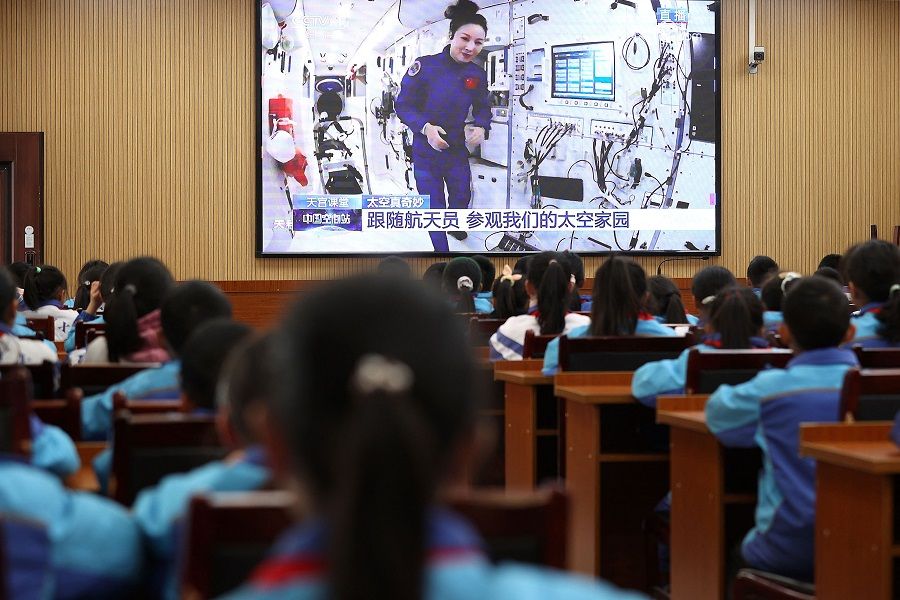 Students watch a live image of a lesson by Chinese astronauts from China's Tiangong space station, at a school in Danzhai, Guizhou province, China, on 9 December 2021. (AFP)