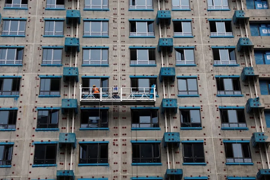 A person works at a residential building construction site in Beijing, China, on 6 September 2023. (Tingshu Wang/Reuters)