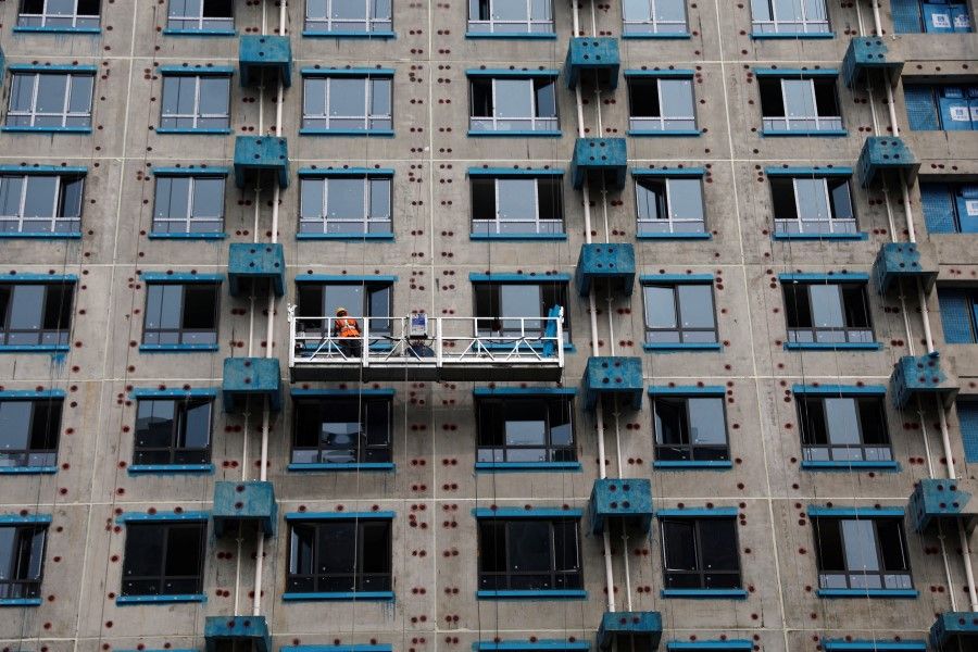 A person works at a residential building construction site in Beijing, China, on 6 September 2023. (Tingshu Wang/Reuters)