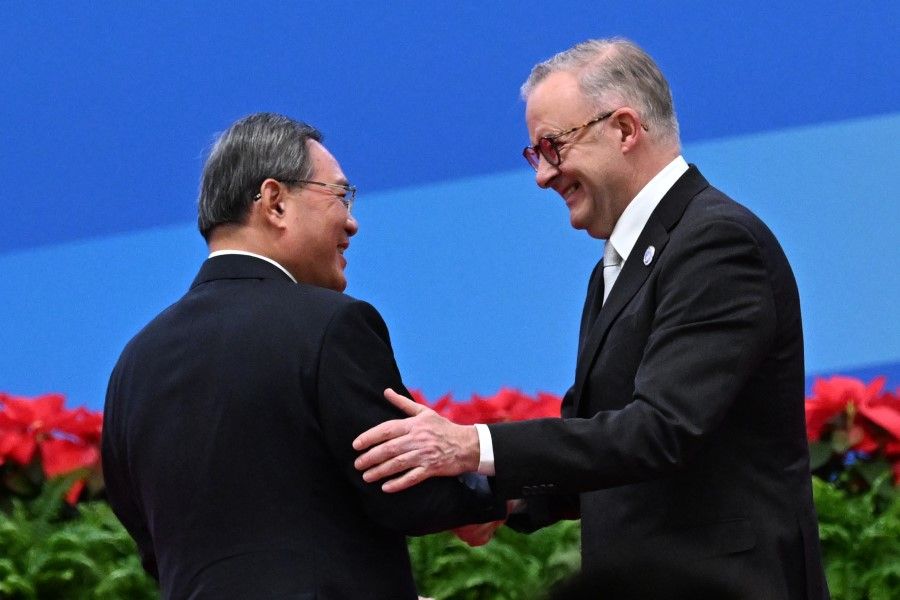 China's Premier Li Qiang (left) and Australia's Prime Minister Anthony Albanese shake hands during the opening ceremony of the 6th China International Import Expo (CIIE) in Shanghai on 5 November 2023. (Hector Retamal/AFP)
