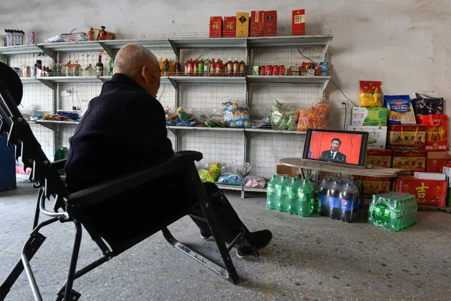A man watches the opening session of the 20th Chinese Communist Party Congress at a store in Fuyang, Anhui province, China, on 16 October 2022. (AFP)