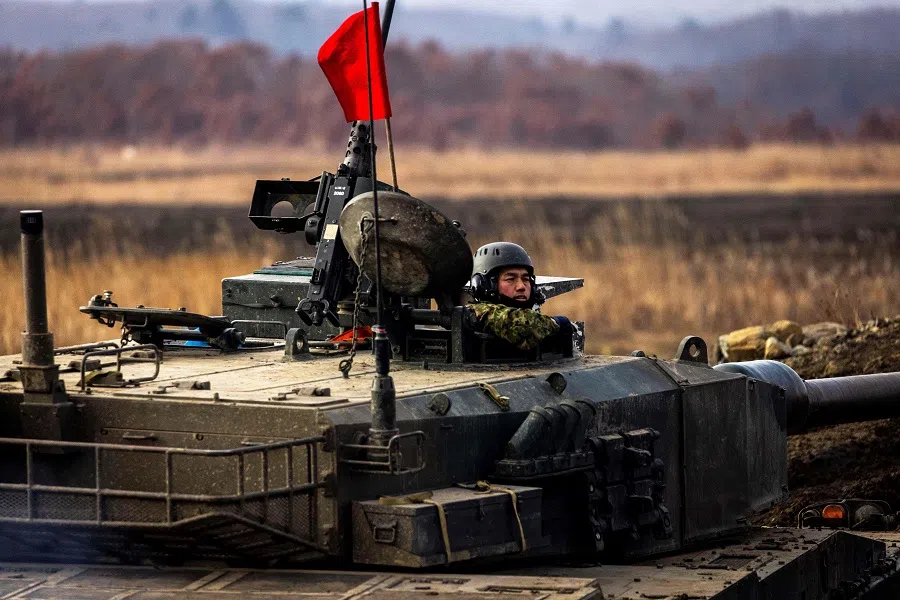 A Japan Ground Self-Defense Force Northern Army Type-90 tank participates in a live tank firing competition at the Hokkaido Great Maneuvering Ground in Eniwa, Hokkaido prefecture, Japan, on 7 December 2021. (Behrouz Mehri/AFP)