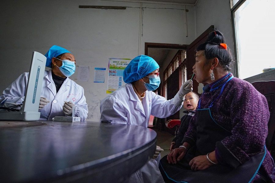 Medical workers conduct health checks on local people in a rural area in Danzhai, in China's southwestern Guizhou province on 1 December 2023. (AFP)