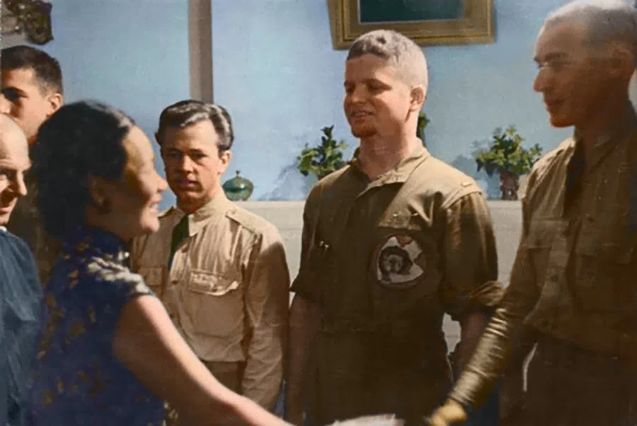 Madame Chiang shakes hands and exchanges smiles with pilots in the Doolittle Raid.