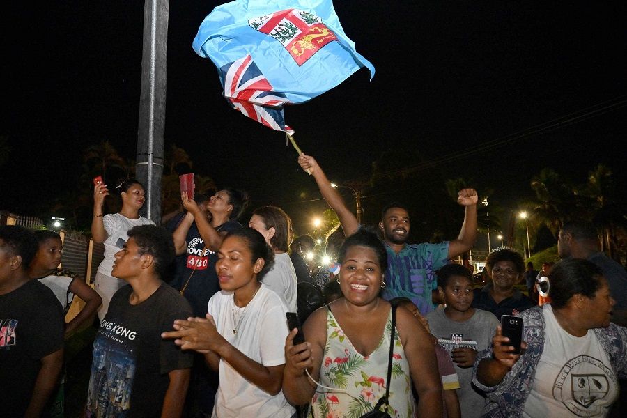Workers and supporters of the People's Alliance Party celebrate after securing the support of the Social Democratic Liberal Party (SODELPA) to form a new government in Suva, Fiji, on 20 December 2022. (Saeed Khan/AFP)