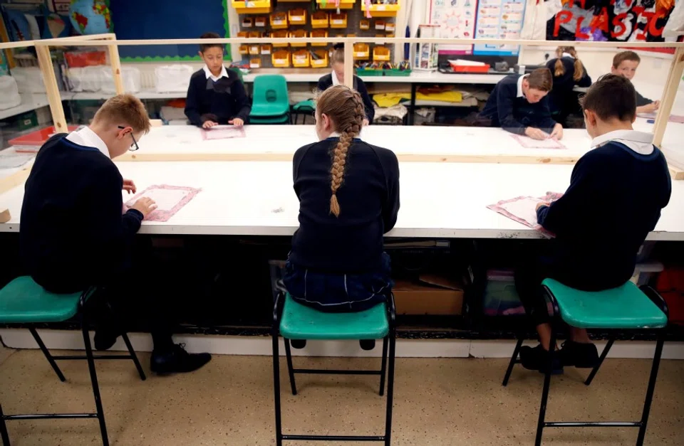 Children sit in a classroom on their first day of school at Heath Mount, amid the outbreak of the coronavirus disease (Covid-19), in Watton at Stone, the UK, on 3 September 2020. (Andrew Couldridge/Reuters)