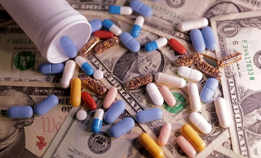 US dollar banknotes and medicines are seen in this illustration taken, 27 June 2024.