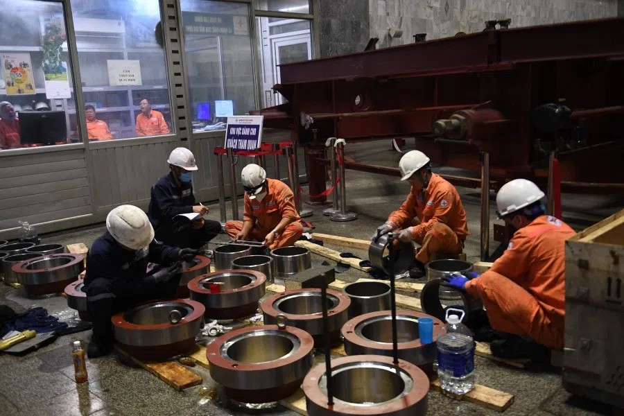Workers at the Hoa Binh hydropower plant in Vietnam's Hoa Binh Province on 18 February 2023 (Nhac Nguyen/AFP)