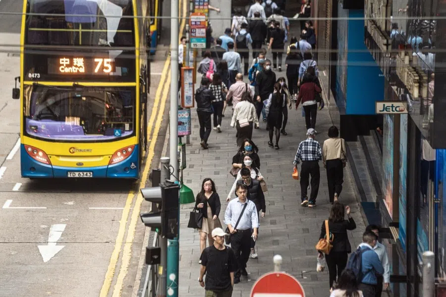 Pedestrians along a road in Hong Kong, China, on 24 April 2023. (Lam Yik/Bloomberg)