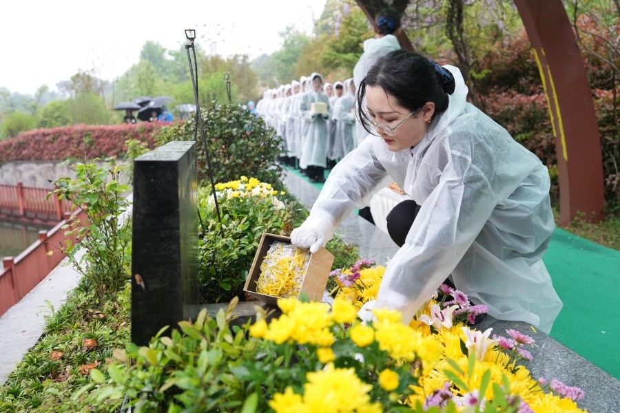 A woman offers flowers at a grave during the Qingming Festival, on 3 April 2024. (CNS)