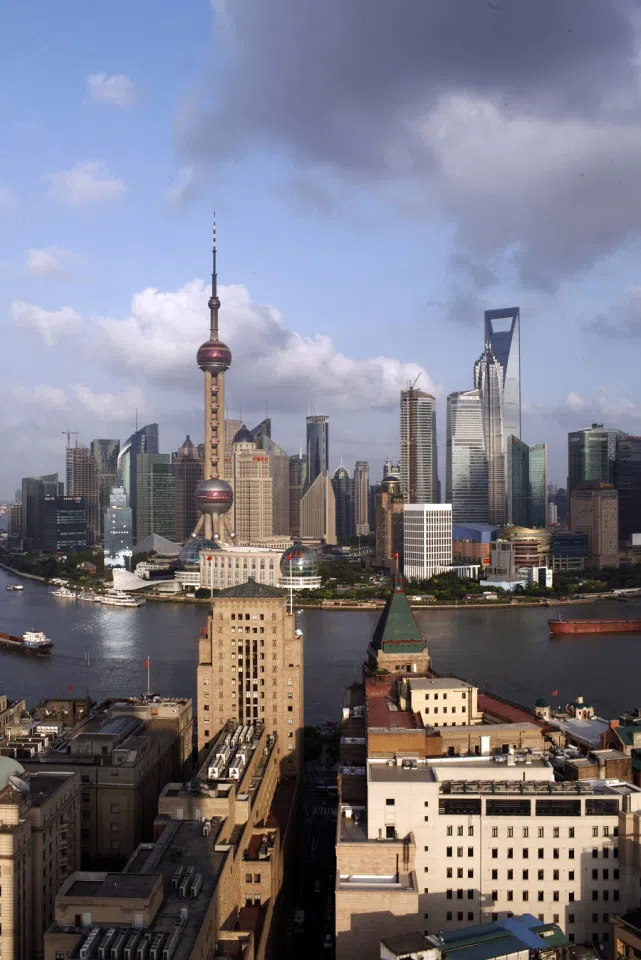 The historic Bund sits in the foreground with the Lujiazui financial district on the other side of the Huangpu river in Shanghai, China, on 19 September 2010. (Shen Qilai/Bloomberg)