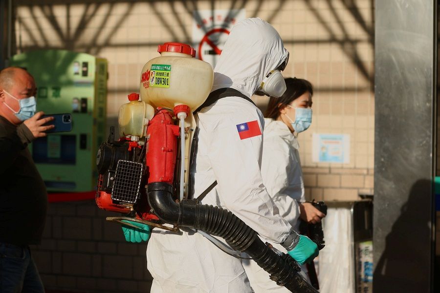 Soldiers prepare to spray disinfectant outside the Taoyuan General Hospital, in Taoyuan, Taiwan, 19 January 2021. (Ann Wang/Reuters)