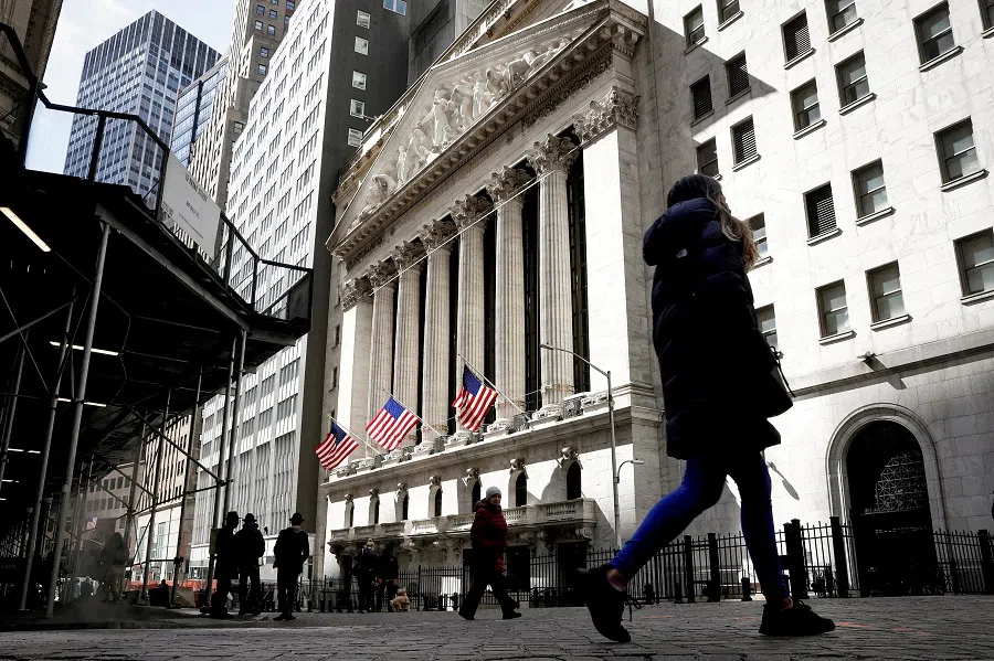 People are seen on Wall Street outside the New York Stock Exchange in New York City, US, 19 March 2021. (Brendan McDermid/File Photo/Reuters)
