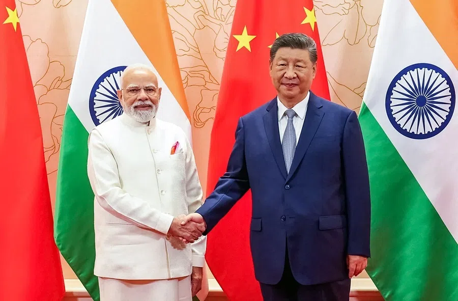 In this handout photograph taken on 31 August 2025 and released by the Indian Press Information Bureau (PIB), India’s Prime Minister Narendra Modi (left) and China’s President Xi Jinping shake hands during a bilateral meeting on the sidelines of the Shanghai Cooperation Organisation summit in Tianjin.