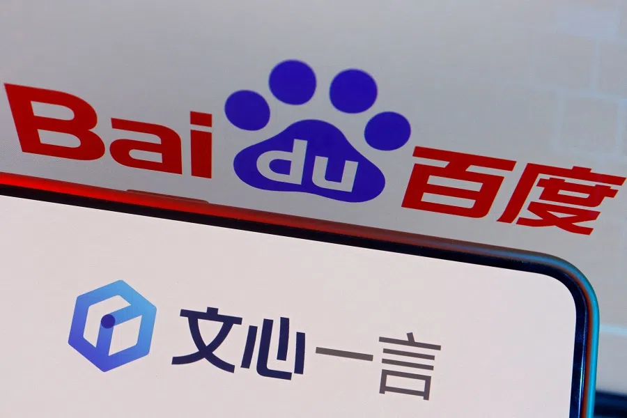 The logo of Baidu’s AI chatbot ERNIE Bot is displayed near a screen showing the Baidu logo, in this illustration picture taken on 28 June 2023. (Florence Lo/Illustration/Reuters)