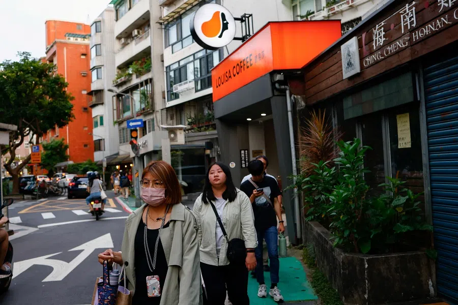 People walk on a street in Taipei, Taiwan, on 18 May 2024. (Ann Wang/Reuters)