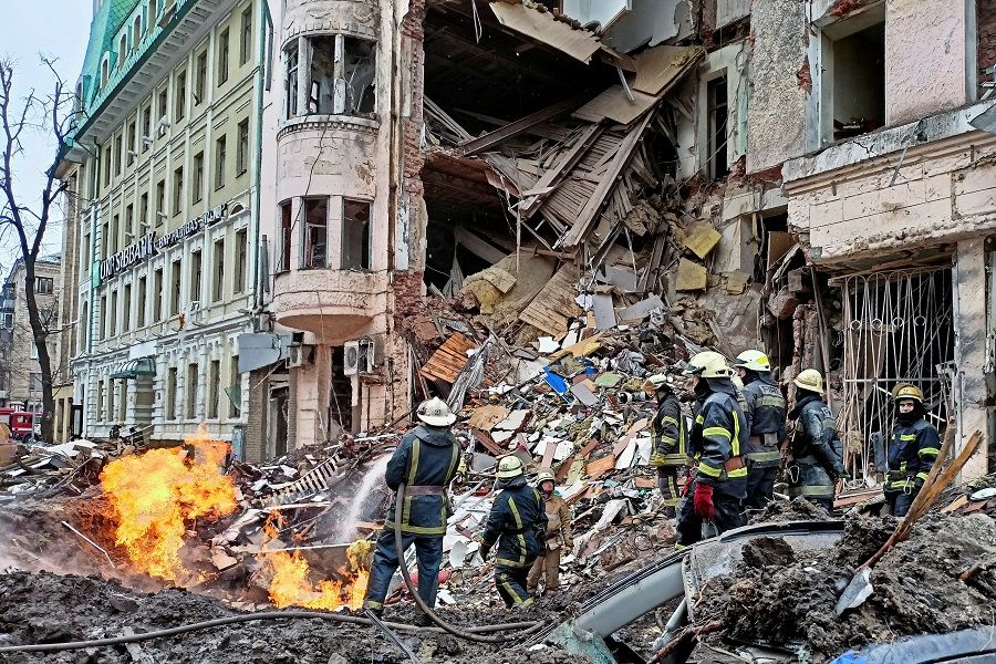 Rescuers work next to a building damaged by air strike, as Russia's attack on Ukraine continues, in Kharkiv, Ukraine, 14 March 2022. (Vitalii Hnidyi/Reuters)