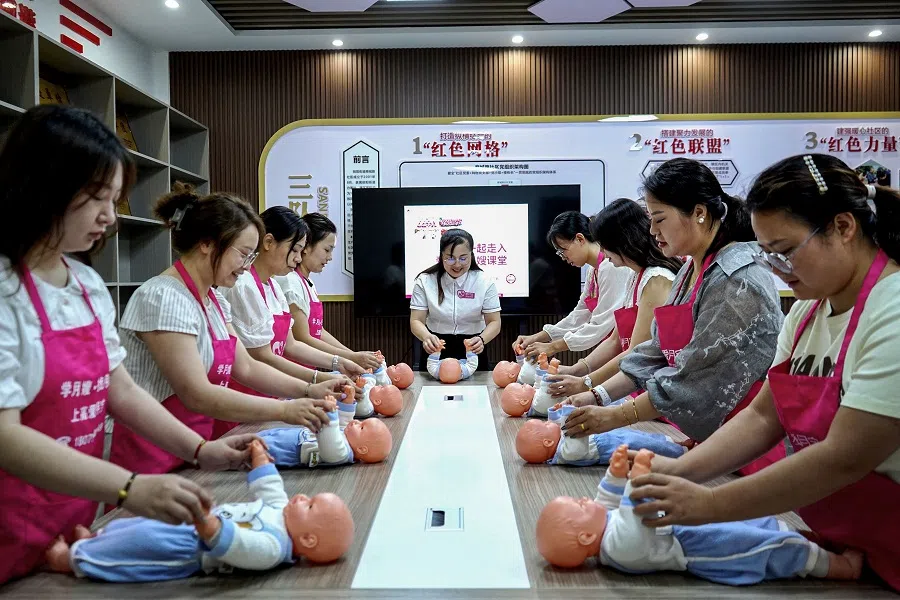 Women at an infant care class in a neighbourhood committee in Yichun, in central China’s Jiangxi province on 21 August 2024. (AFP)