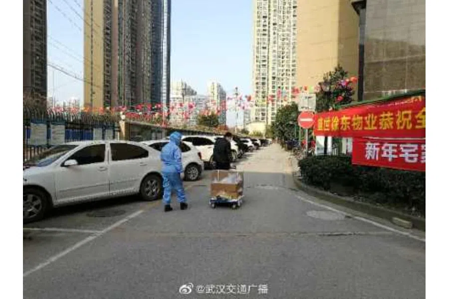 Volunteers collecting parcels for blocks of residents.