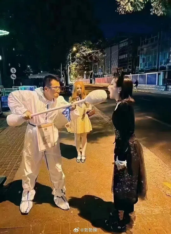 People dressed as China's "Big White" army, carrying giant cotton buds and "swabbing" other participants in the Halloween parade. (Weibo)