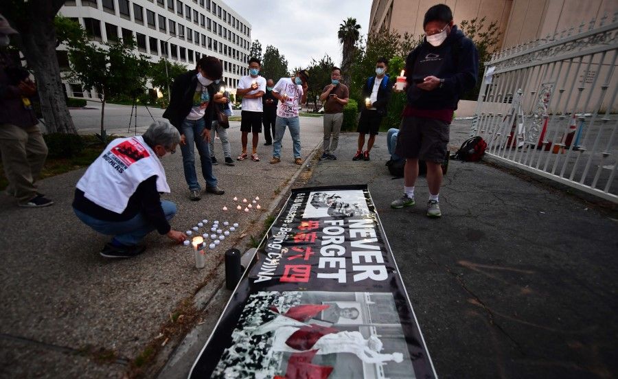 Activists lay candles for a vigil across the road from Chinese consulate in Los Angeles, California, 4 June 2020 commemorating the 31st anniversary of the Tiananmen incident of 4 June 1989 in Beijing. (Frederic J. Brown/AFP)