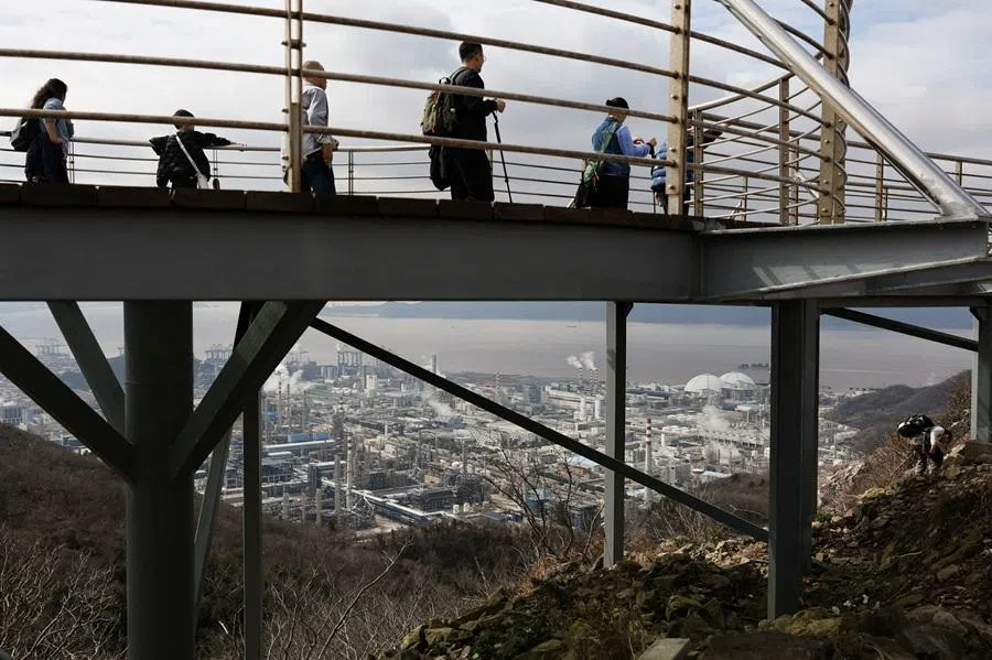 People walk on a viewing platform in Ningbo, Zhejiang, China, on 21 March 2026. (Go Nakamura/Reuters)