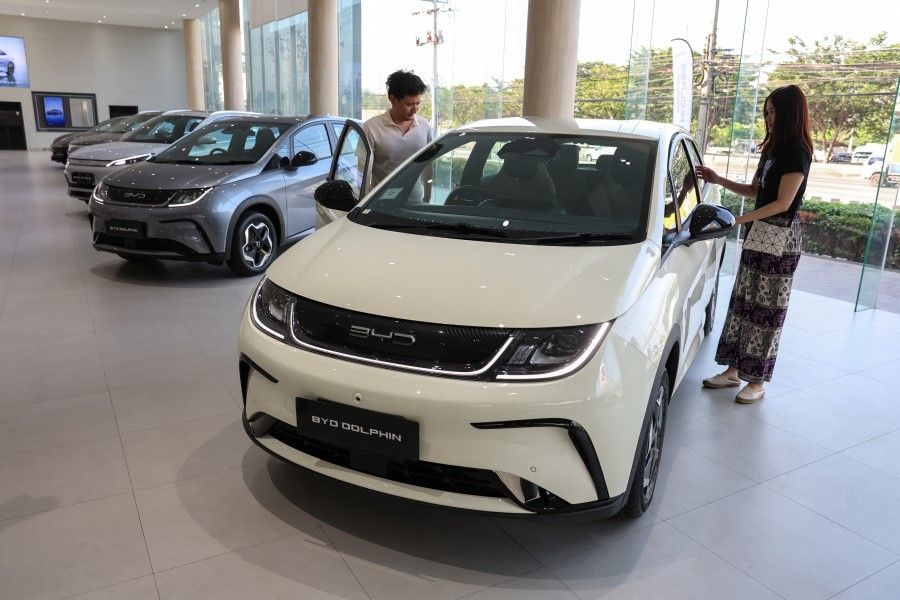 Visitors view a BYD Dolphin EV car at a BYD show room in Bangkok, Thailand, on 17 January 2024. (Athit Perawongmetha/Reuters)