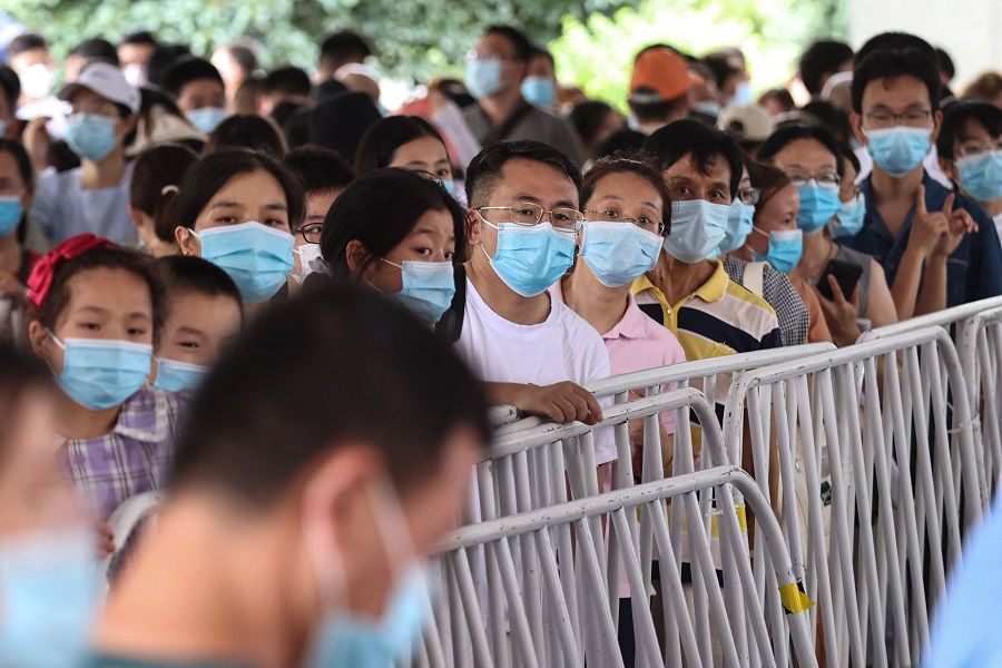 Residents queue to receive nucleic acid tests for the Covid-19 coronavirus in Nanjing, Jiangsu province, China, on 21 July 2021. (STR/AFP)