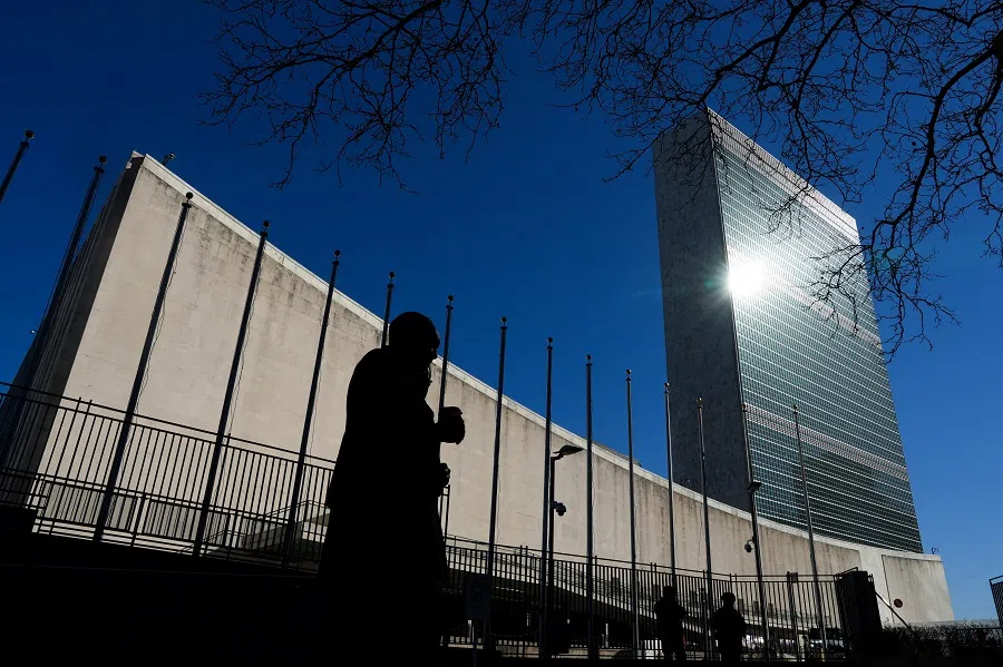 People walk outside the United Nations headquarters in New York City, US, on 18 March 2025. (Adam Gray/Reuters)