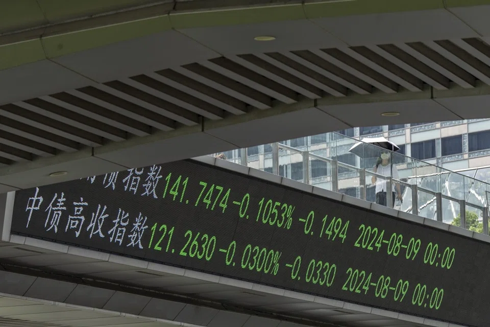 An electronic ticker displays stock figures in Pudong’s Lujiazui Financial District in Shanghai, China, on 14 August 2024. (Qilai Shen/Bloomberg)