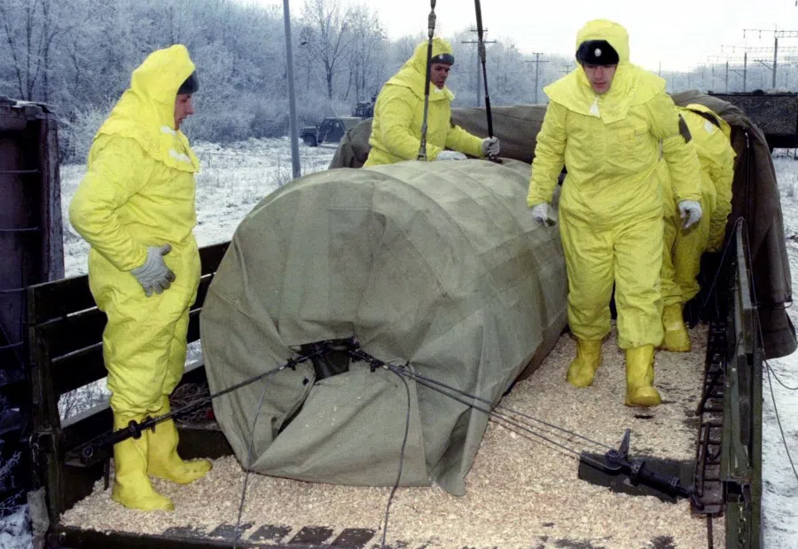 A nuclear warhead is loaded from a rail car onto a truck during exercises intended to train specialised personnel how to cope with possible accidents during the transport of nuclear materials in the outskirts of Kirovograd, 7 December 2021. Ukraine is steadily transferring its share of the former Soviet nuclear arsenal to Russia for destruction under international treaties. (Stringer/Reuters)