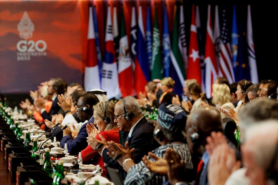 Delegates applaud during the handover ceremony at the G20 Leaders' Summit, in Nusa Dua, Bali, Indonesia, 16 November 2022. (Willy Kurniawan/Reuters)