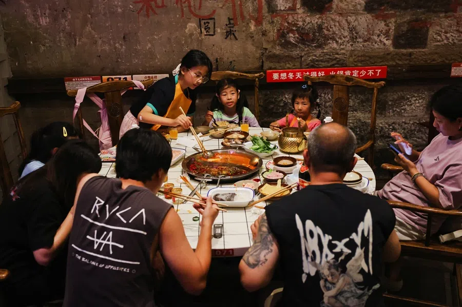 People dine at a restaurant in Chongqing, China, on 31 July 2025. (Go Nakamura/Reuters)