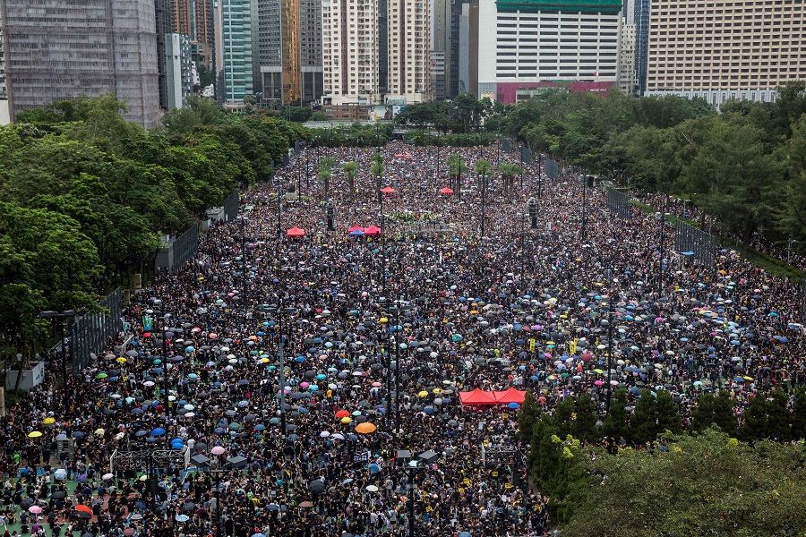 In this file photo taken on 18 August 2019, protesters gather for a rally in Victoria Park in Hong Kong, in opposition to a planned extradition law that had morphed into a wider call for democratic rights in the semi-autonomous city. (Isaac Lawrence/AFP)