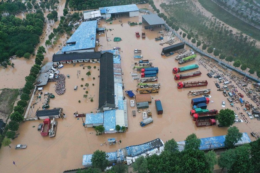 This aerial photo taken on 7 July 2020 shows inundated buildings and vehicles after heavy rain caused flooding in Shexian county, Huangshan city, Anhui province, China. (STR/AFP)