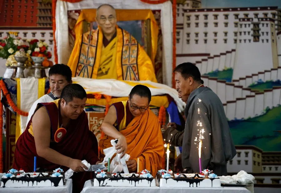 Tibetan monks cut cakes during an event organised to mark the 90th birthday celebration of their spiritual leader, the Dalai Lama, at Jawalakhel Handicraft Center, also known as Tibetan Refugee Camp, in Lalitpur, Nepal, on 6 July 2025. (Navesh Chitrakar/Reuters)